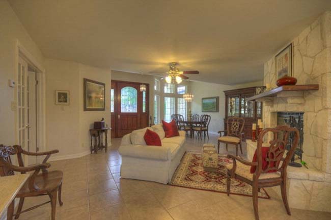Open living room with natural light in executive style custom home